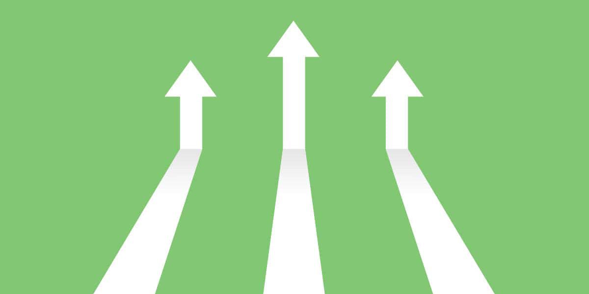 Vector illustration image of white arrows on green background coming in and pointing up to depict increasing trends. Specifically, indicating the topic of the blog post which is digital trends in 2023.
