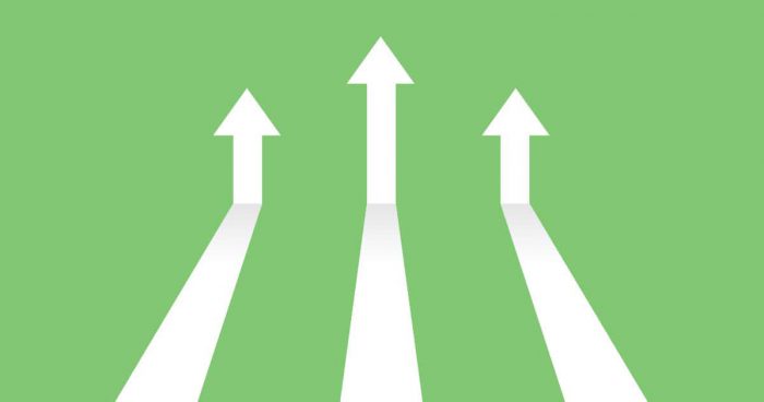 Digital Marketing Trends to Watch in 2023 Vector illustration image of white arrows on green background coming in and pointing up to depict increasing trends. Specifically, indicating the topic of the blog post which is digital trends in 2023.